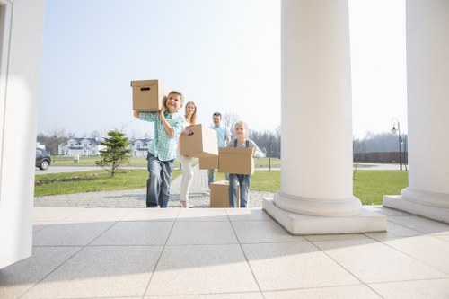 Removal team carrying furniture through a Westminster apartment building