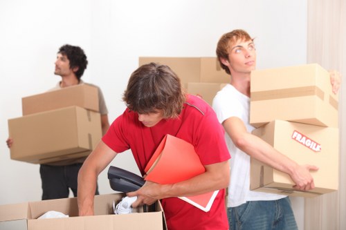 Removal van loading household boxes near a central London property