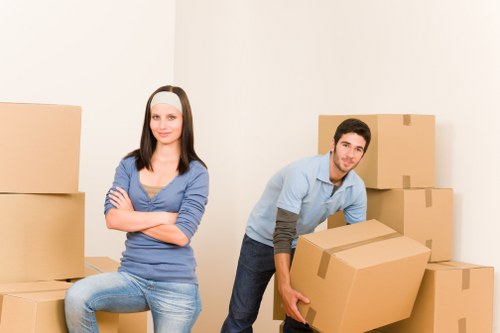 Professional movers carrying furniture during a Westminster relocation