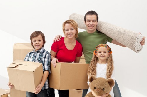 Professional movers carrying boxes through a Westminster apartment building
