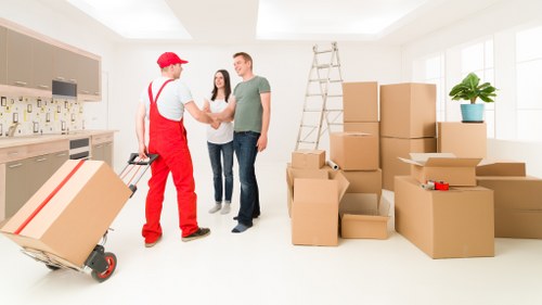 Workers loading old bedroom furniture during a Westminster pickup service