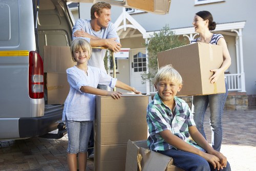 Professional moving team loading items into a Westminster removal van