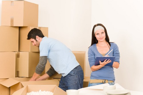 Workers using safe lifting techniques while handling furniture