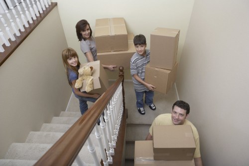 A moving crew organizing furniture and boxes inside a Westminster home